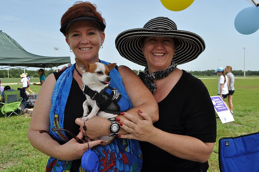 Debi Kleer and Riana Rawson show off Pippi as they sell hot dogs and cupcakes.