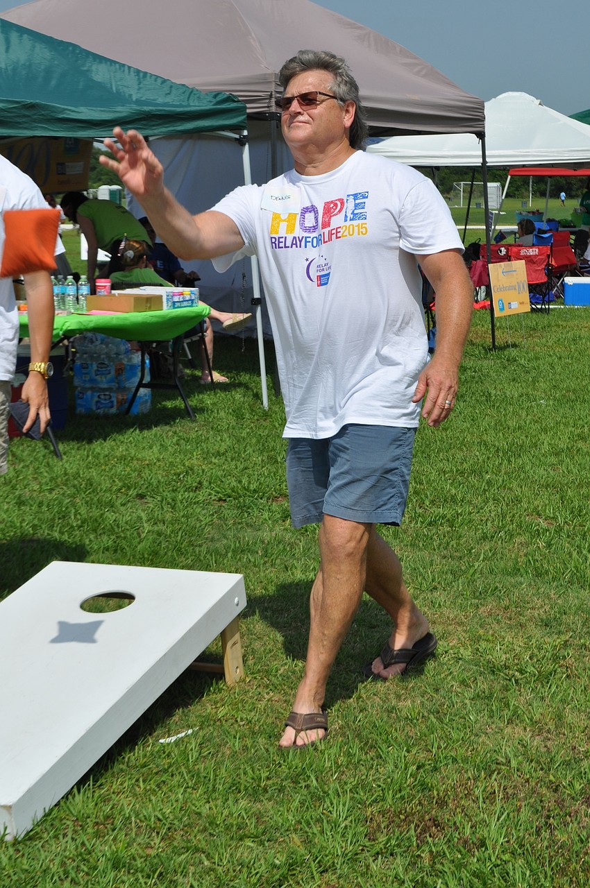 Dennis Barth, on the Beall’s team, plays a game of corn hole with his son, Tristan, and friends.