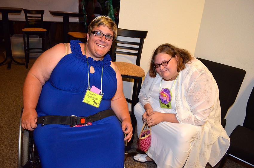 Ashley Applequist and Loree Blowe relax before heading toward their other friends in the main dance room.