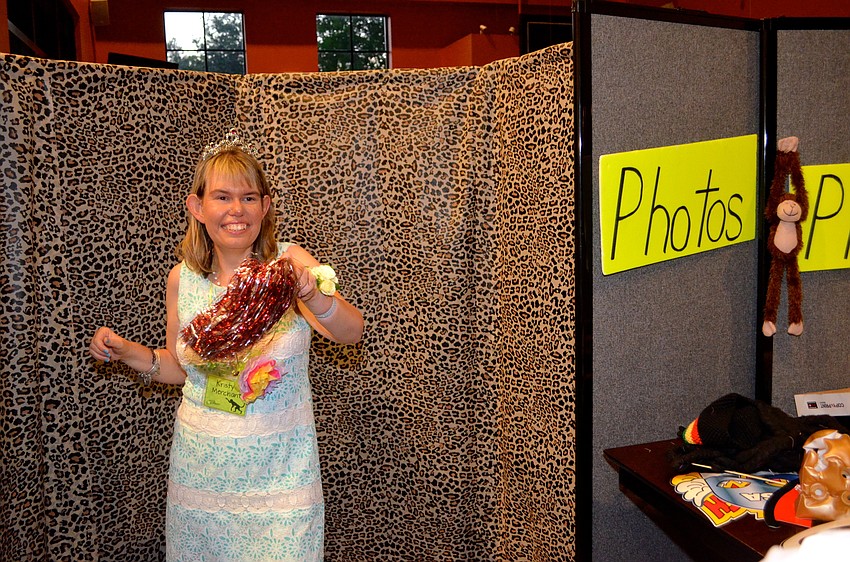 Kristy Merchant plays with props for a photo.