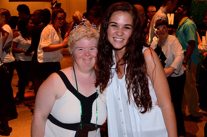 Jennifer Robinson and Taylore Homan dance and laugh on the dance floor.