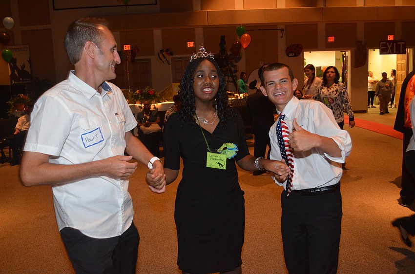 Leaunna Washington dances flanked by volunteers Paul Taylor and Levi Waxler.