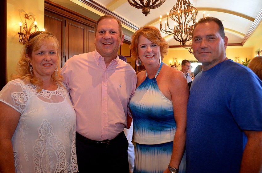 Karen and Richard Fletcher chat with friends Kathleen and John Cucci before finding their seats for dinner.
