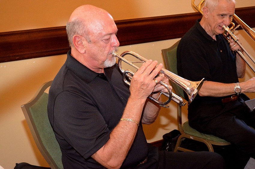 Joe Miller, of the Venice Symphony and Legacy Brass Trio, plays New Orleans-style tunes for attendees.