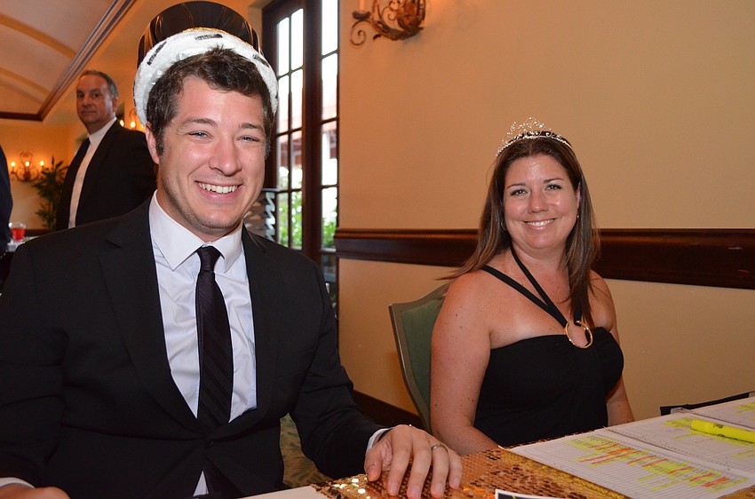 Faculty members Patrick Pollifone and Christa Naylor try on the  crowns for prom king and queen.