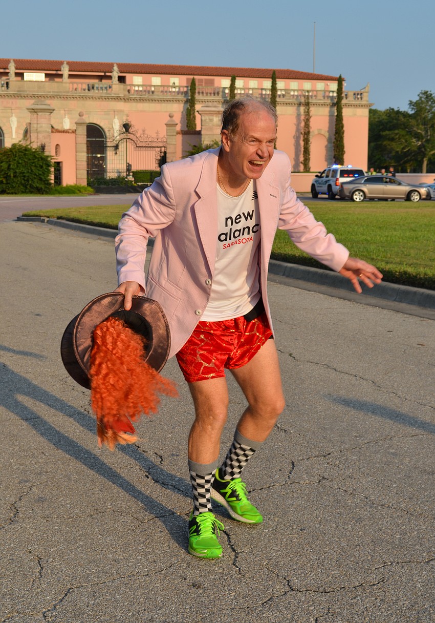 Race Co-Chair Adam Bright cheers on runners before the finish line.