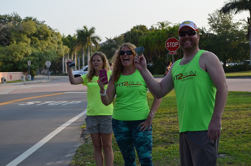 Missy Toler, Kimmi Van Der Veen and Rob Blankenship cheer on runners for the Fit 2 Run team.