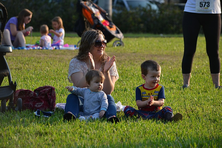Sara Jackson sits with her sons Eli and Wyatt waiting for their grandmother to cross the finish line.