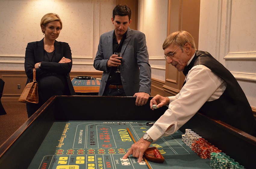 Carly and Daniel Brown listen to the rules before playing with Andy Branco.