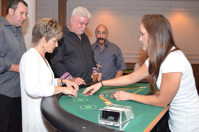 Jodi Sobol and Steve Dragon start a game of blackjack.