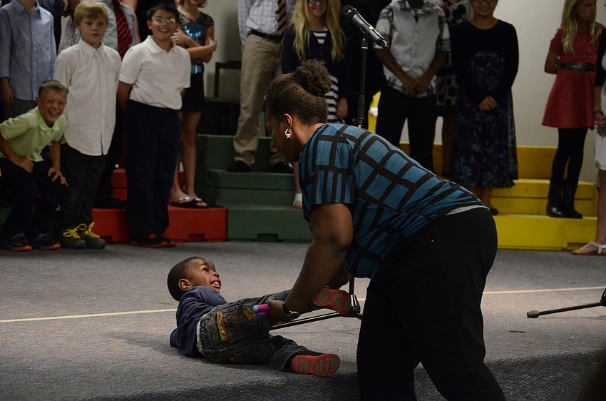 Braylen Heaven, 2, tries to join the fourth-graders on stage before his mom, Stawania, caught him.