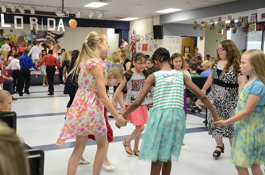 The fourth-graders performed the pioneer washerwoman dance.
