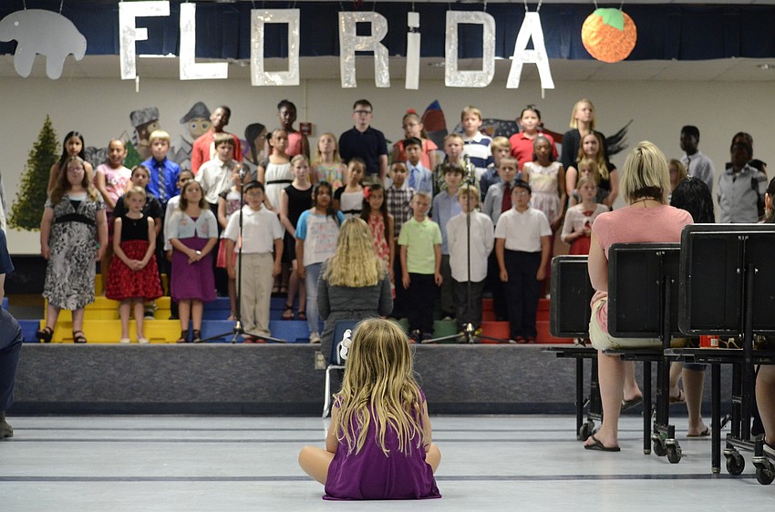 Merina Earl, 5, watched her older brother perform during the Bashaw Elementary fourth-grade program. Merina knew all the words to the songs.