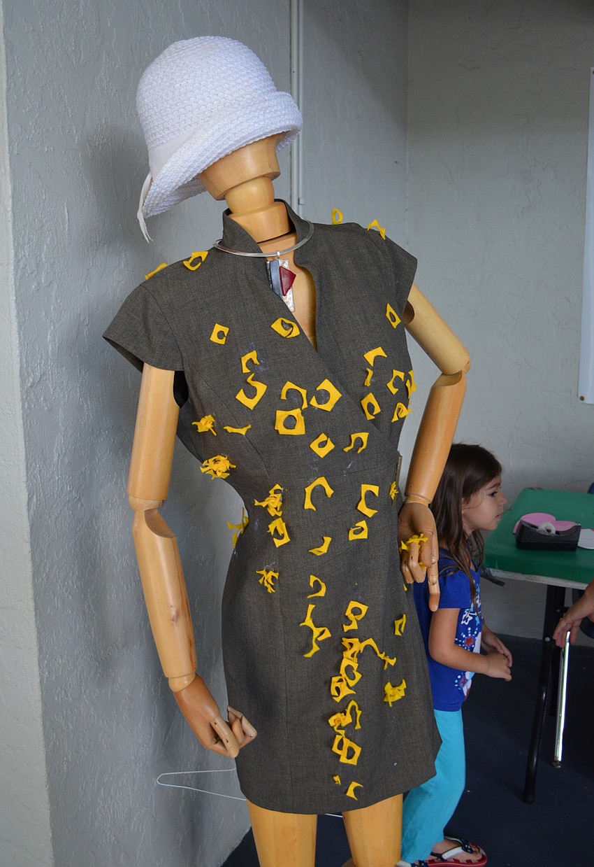 Students decorated a dress that was inspired by the iConcept Fashion Show that utilizes unconventional materials to make clothing.