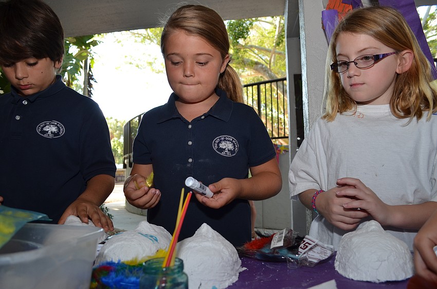 Students made masks using plaster on a mold and then decorated them.
