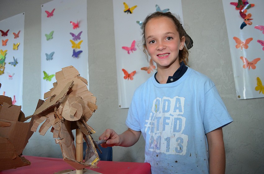 Earlier students made cardboard sculptures of different animals and painted them.