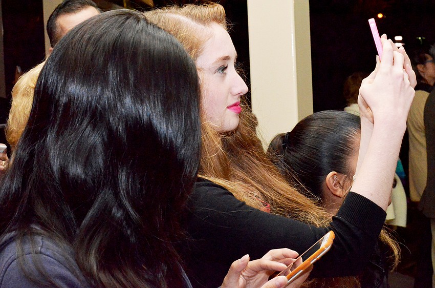 Crystal Ke, Tonirenee Taylor and Olivia Ratner record the fireworks show on their phones.