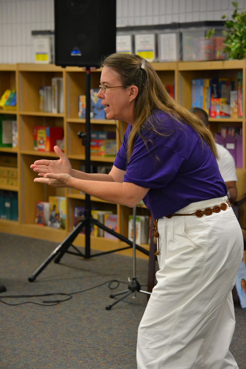 Debbie Mondale demonstrates how to make sounds like a storm.