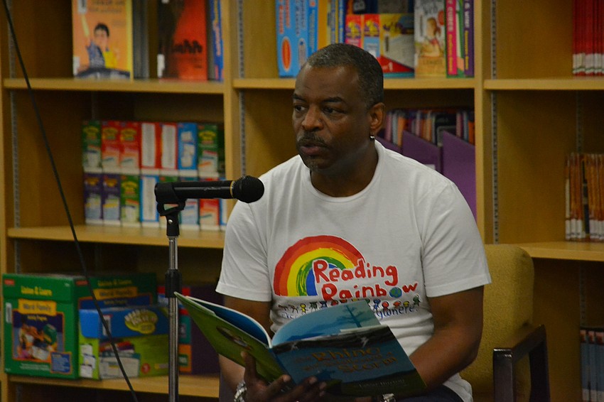 LeVar Burton reads his book “The Rhino who swallowed a storm” to students.