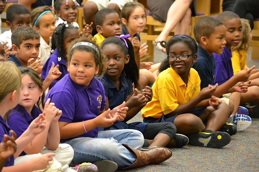 Students snap their fingers to make the sound of rain falling.