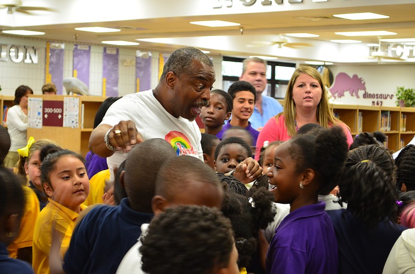 LeVar Burton talks to students as they swarm around him.