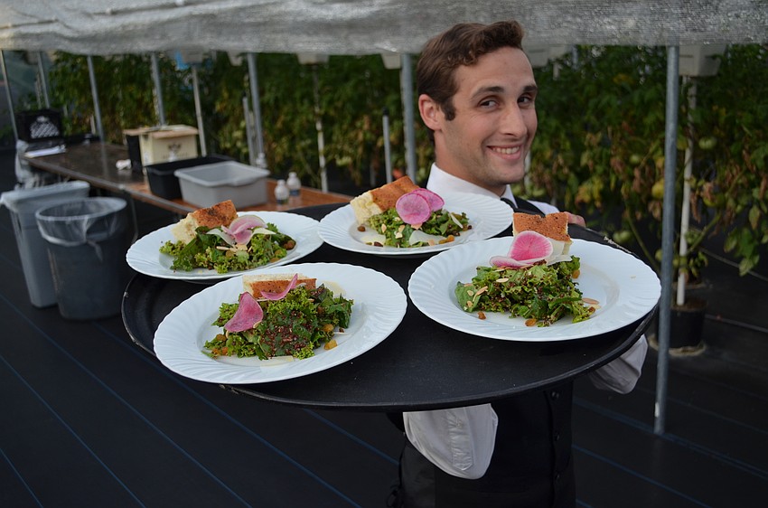 A Mattison’s waiter brings out the opening culinary salvo with salad.