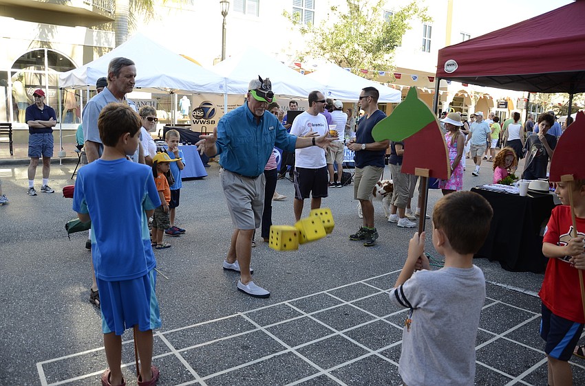 Dean Burnside, a volunteer with Center for Building Hope, rolls the dice to 