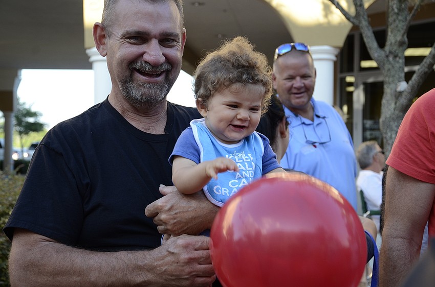 Dylan Hutson, 8 months, plays with a balloon with his uncle, Mike Blevins.