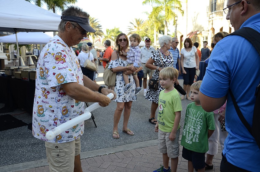 Trebor Britt makes balloons at Music on Main.