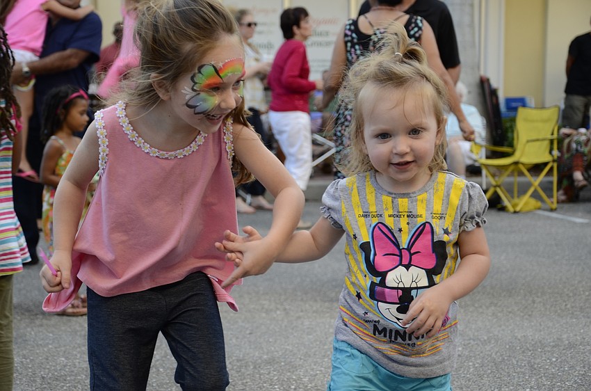 Zoey Kollet, 4, dances with her sister, Cora, who is a year and a half old.
