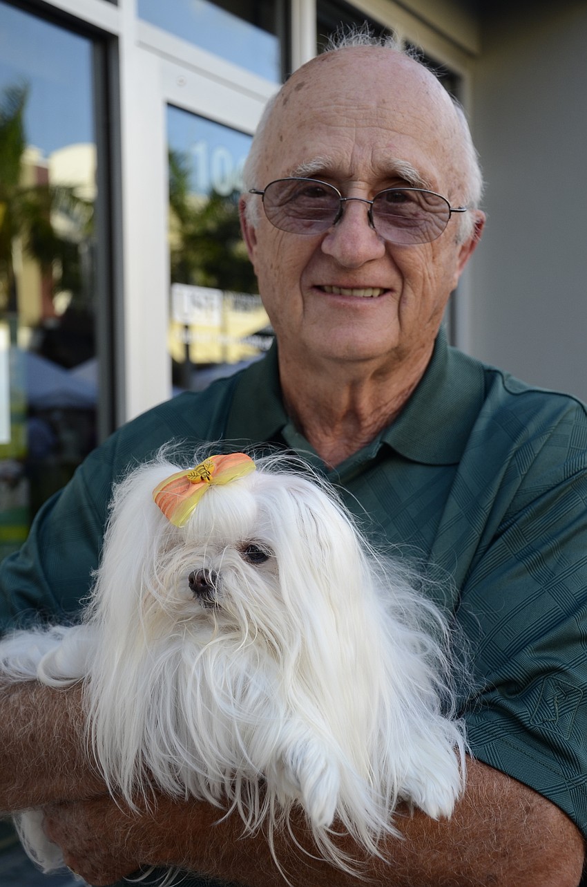 Stan Goble holds Issa, a therapy dog.