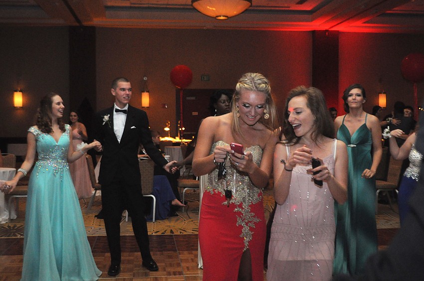 Savannah Camastro and Cat Murphy check out their photos from the dance floor.