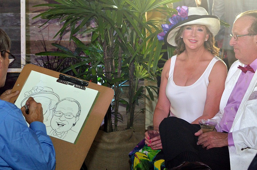 Co-Chair Merrill Bonder and Jeff Bronze get a caricature drawn at Going for the Gold.