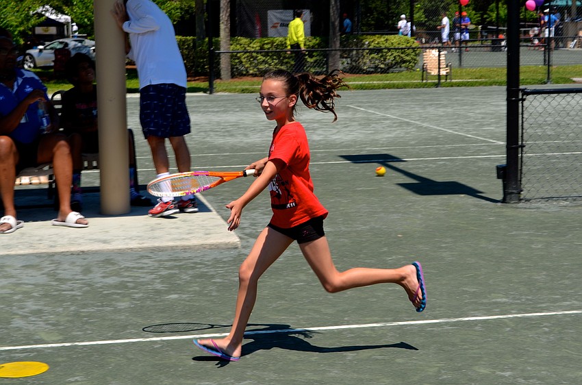 Rylee Volk chases after a ball her mother served over the net.