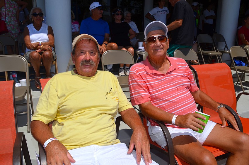 Juergen Mader and Guy Larreur enjoy cold drinks on a warm afternoon.
