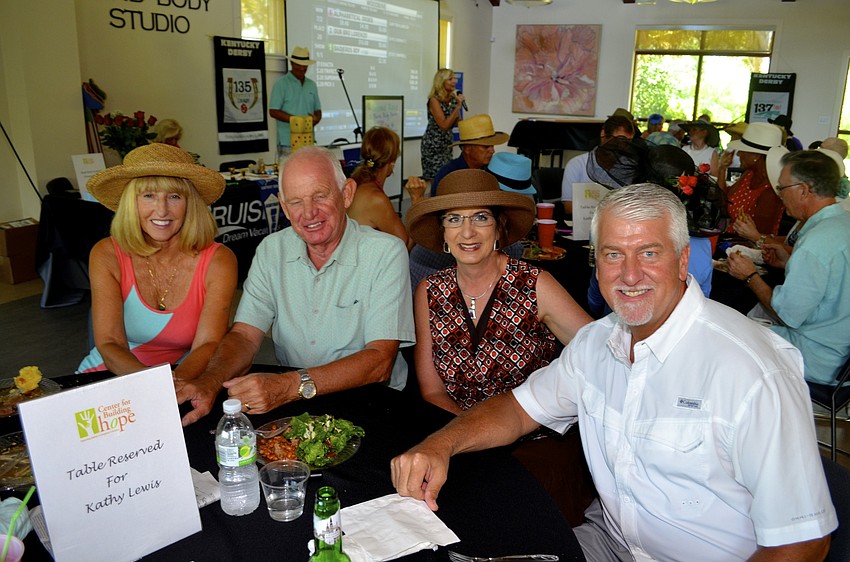 Couples Rosemary and Tony Kenyon and Terri and Dean Burnside enjoy laughs and a fast-paced horse race.