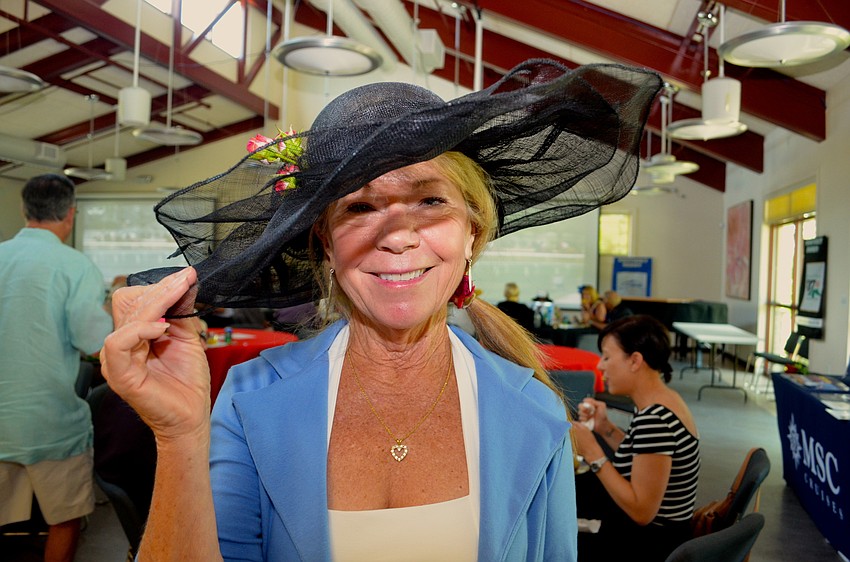 Kathy Lewis sports a large black hat to show her Derby enthusiasm.