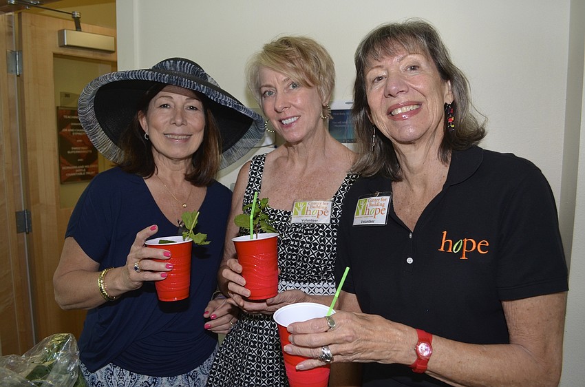 Event co-host Julie Sauer enjoys a drink with friends and event volunteers Helen Zielinski and Deborah Bergman.