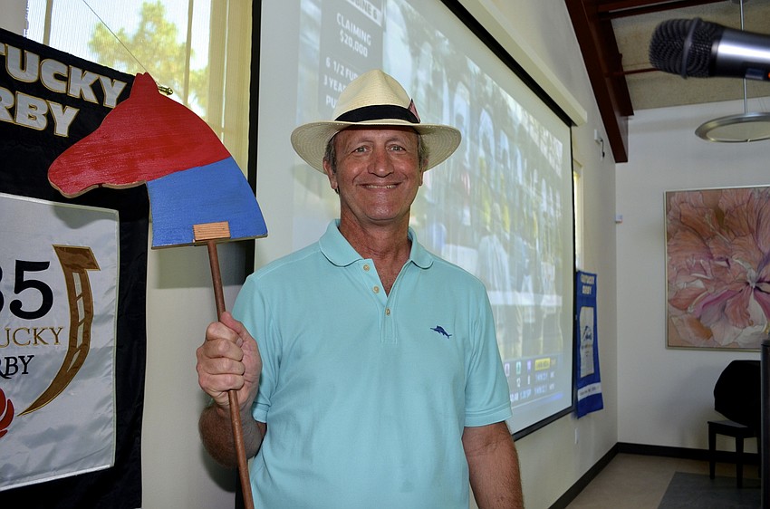 Event host H.J. Sauer auctions off a horse for participants to root for during the Derby.