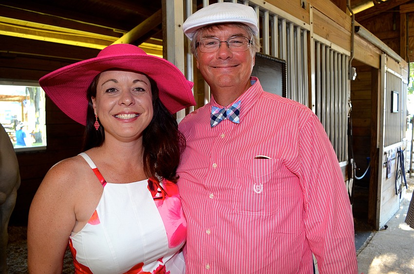 Tiffani and Jim Gentsch enjoy time with the horses at the event, even though one tried to eat her hat.