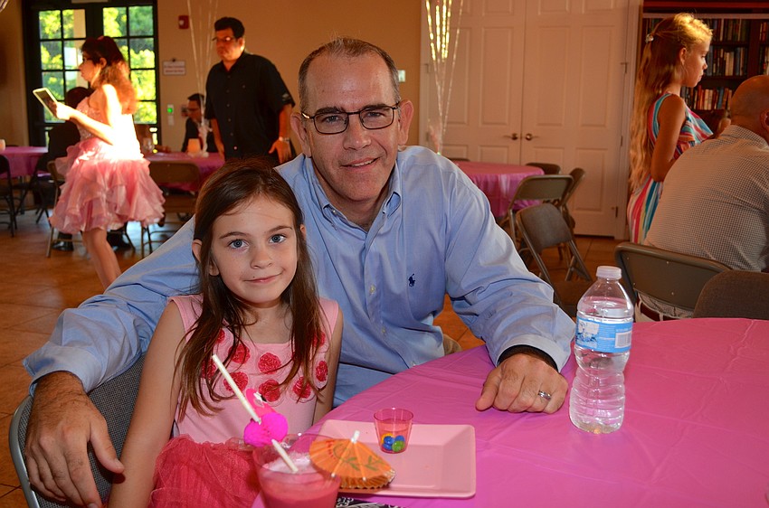 Avery McKee and her father, Scott, enjoy cold drinks on a warm evening.