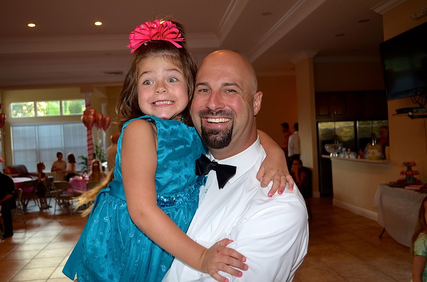 Annie Rustin acts silly with her father, Dino, while enjoying pop music.