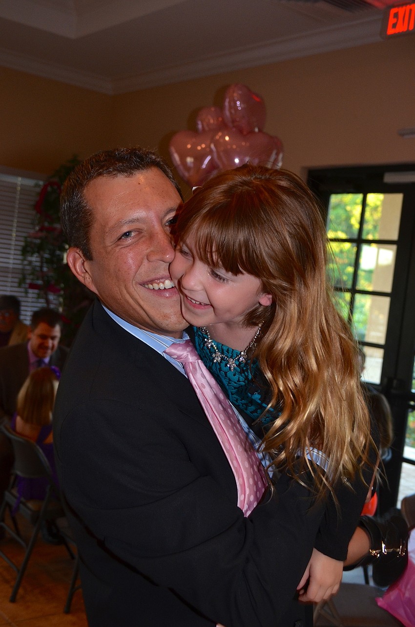 George Kruse takes a break from dancing to tickle his daughter, Olivia.