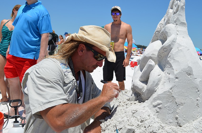 Contest judge and sand sculpture Andy Dailey creates a piece to celebrate the 43rd annual event.