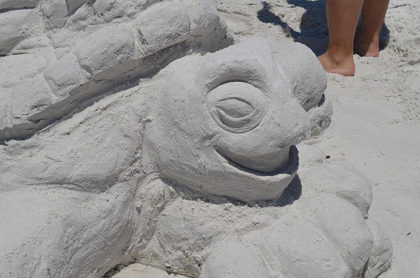 This turtle is holding up a castle on his shell.