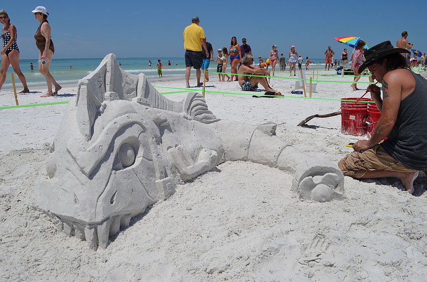 Damon Meri works on finishing his sculpture that he named “Here Fishy Fishy.”