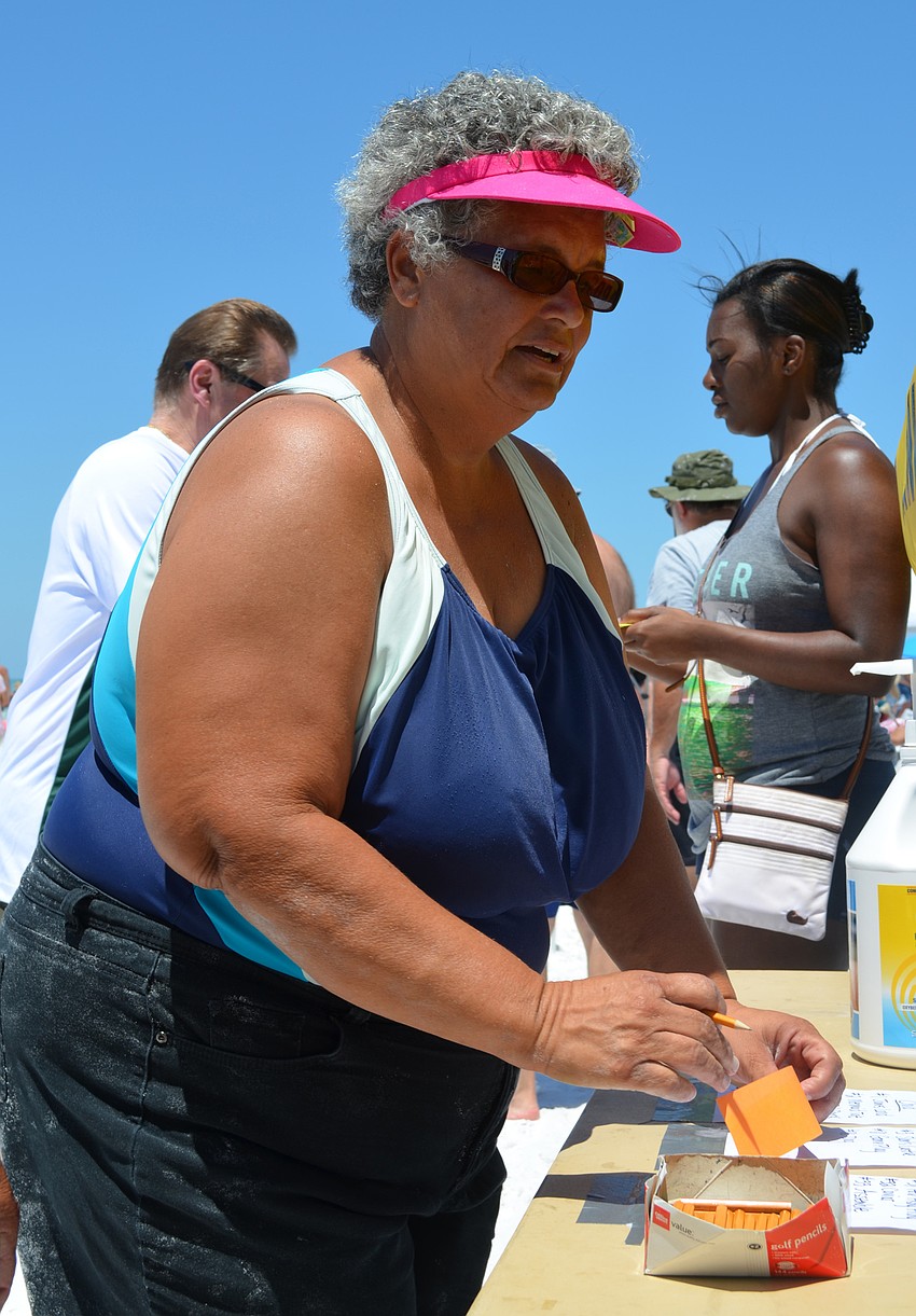 Lucille Richardson casts her vote for her favorite sand sculpture.