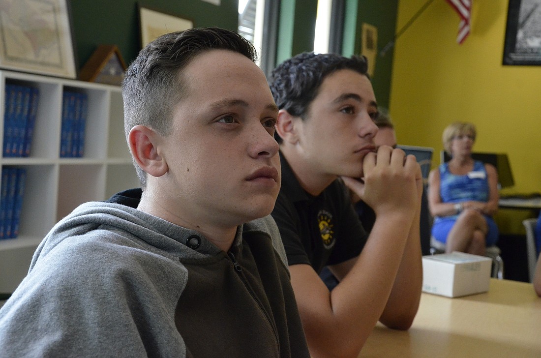 Dawson Young and Nick Petruccelli listen to a presentation by Robert Rehmer.