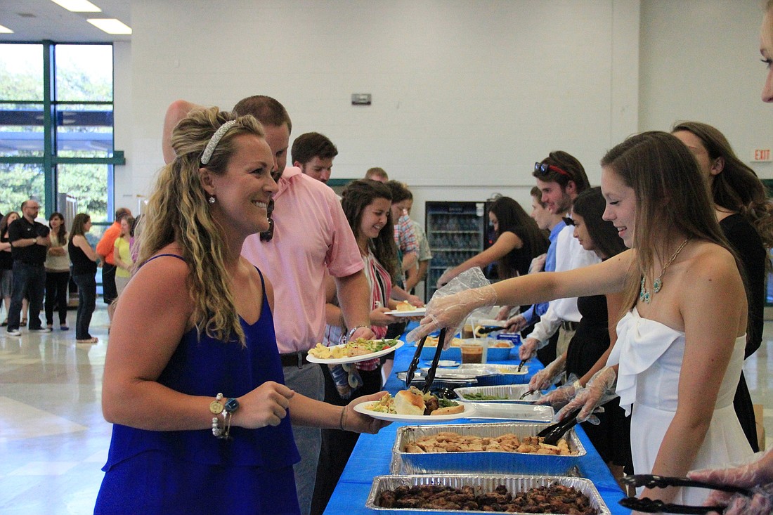 Lakewood Ranch High students serve faculty and guests dinner before the April 22 program begins. Courtesy photo