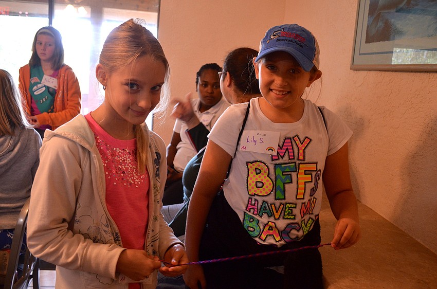 Michelle Mather and Lily Slavinski put the final touches on their bracelets.